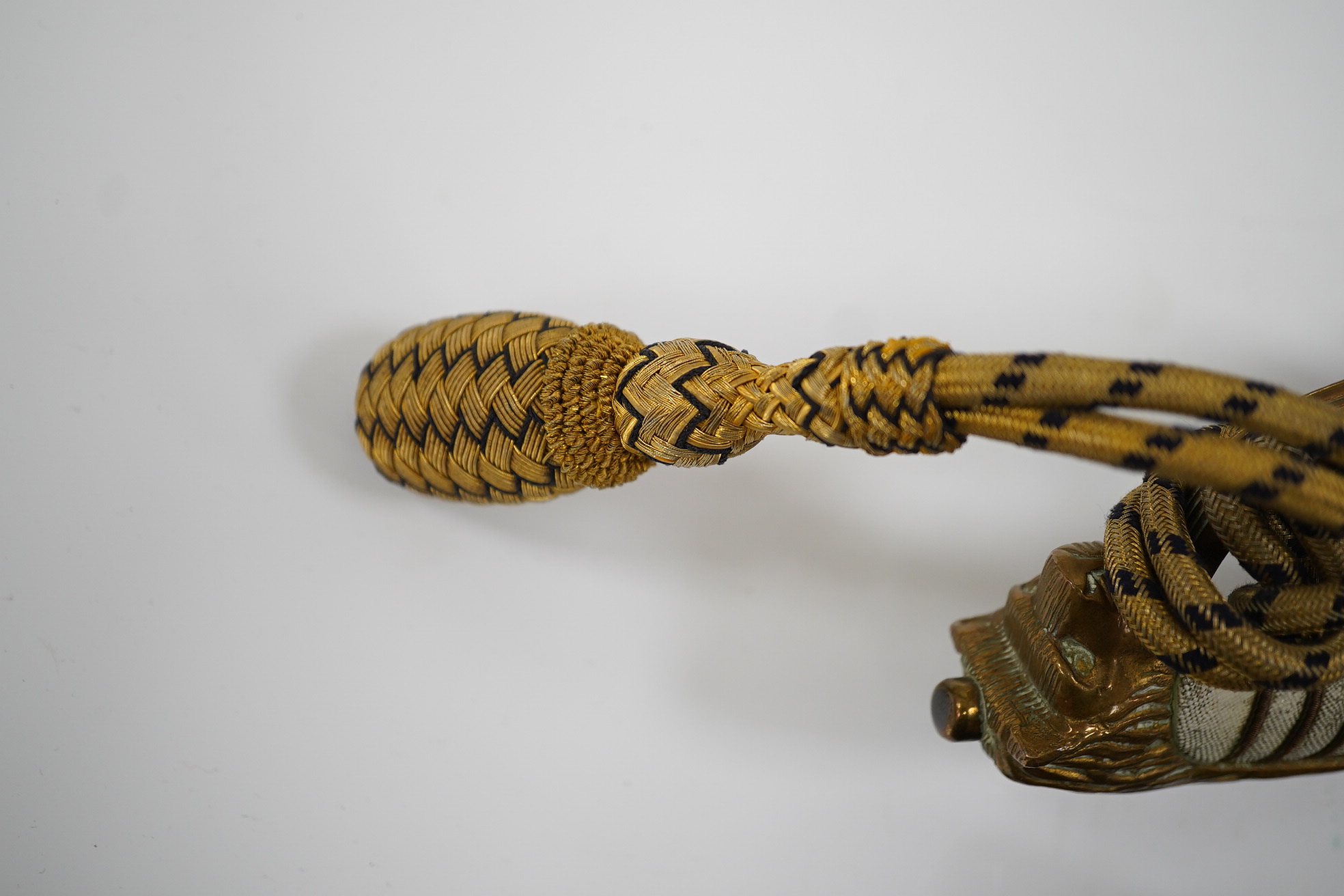 An 1846 pattern naval officer’s sword by Gieves, with folding thumb guard and knot, in its leather scabbard with brass mounts. Together with its outer soft leather cover. Condition - fair, notable wear to grip.